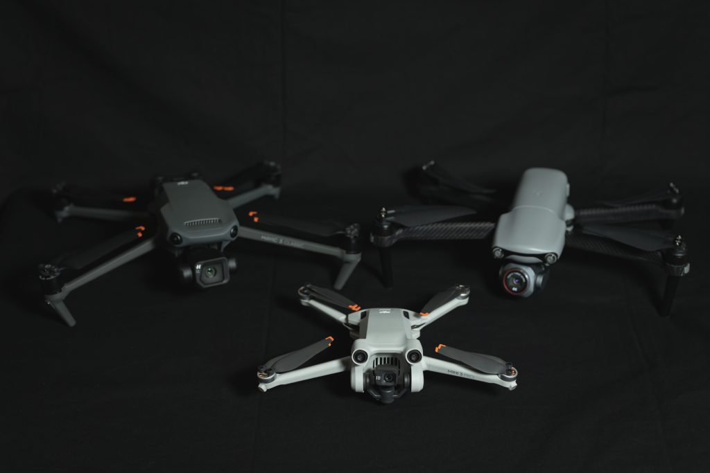 DJI mini 3 pro and Mavic 3 classic, Autel Evo lite plus on the table.