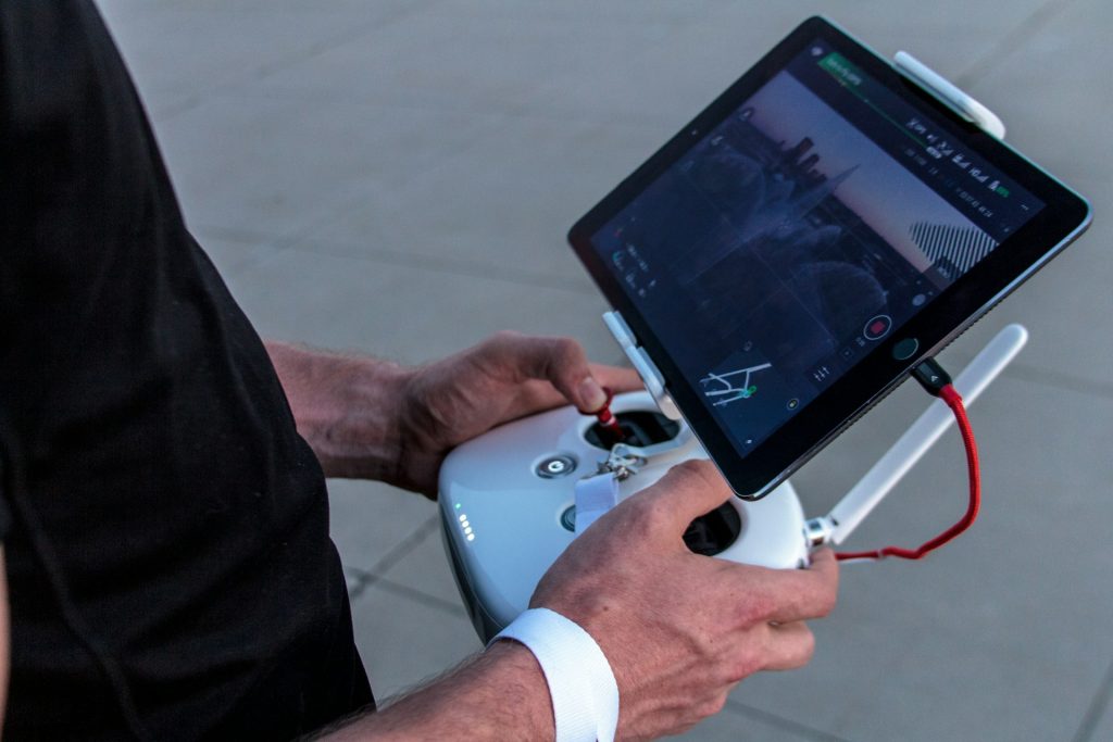 A person piloting using a remote controller with a screen.