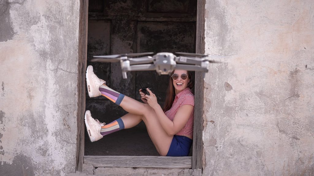 A happy girl talking a selfie with a drone