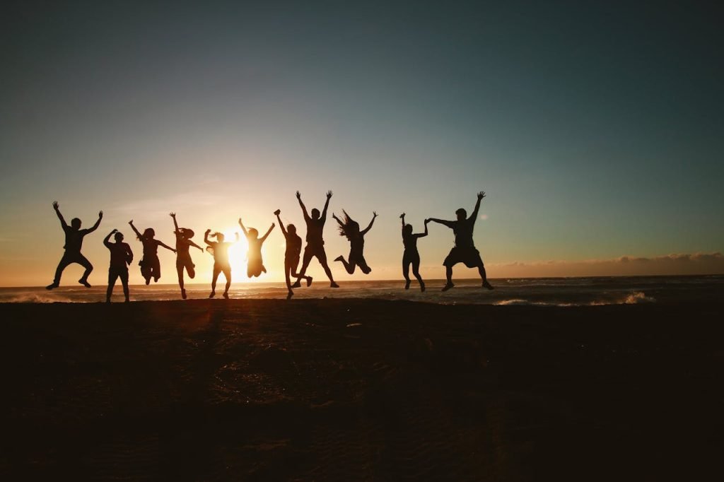  A group of people’s silhouettes can be considered they are jumping to take a photo