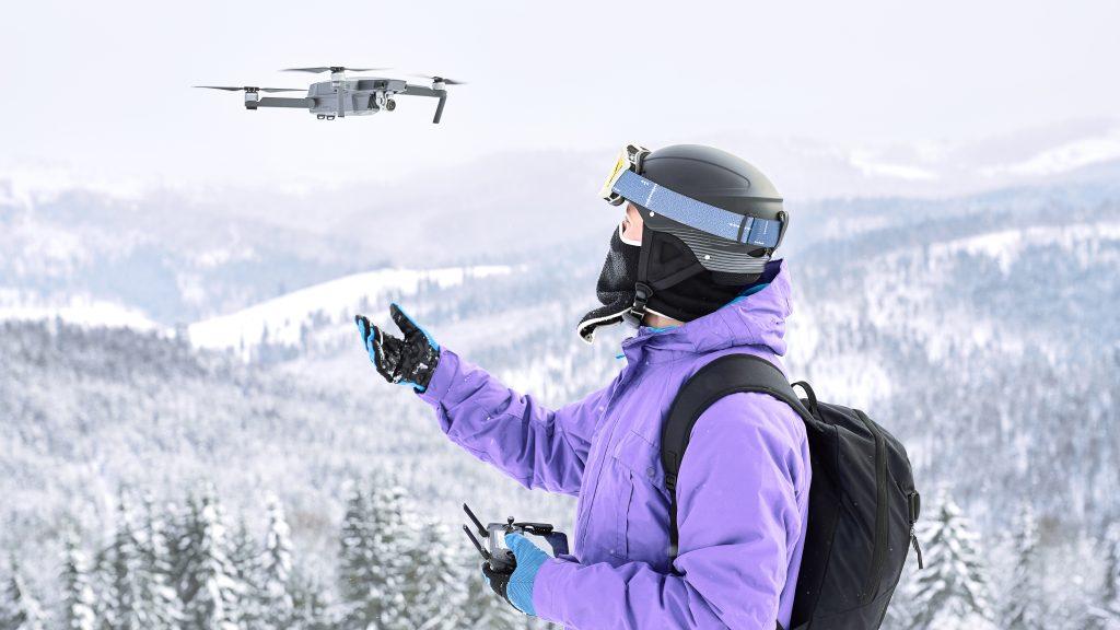 A person flying a drone in snowy weather